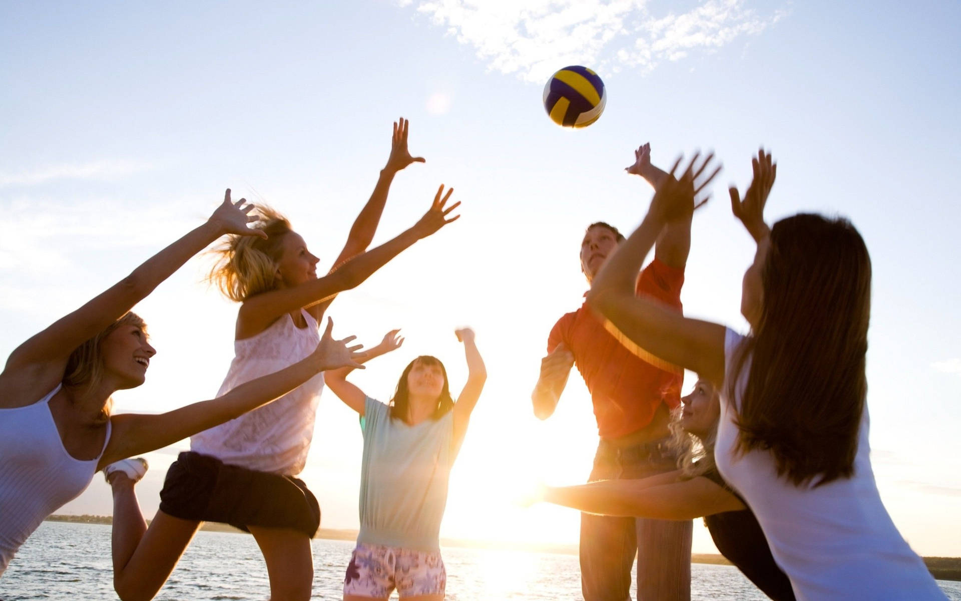 Young People Playing Beach Volleyball Background