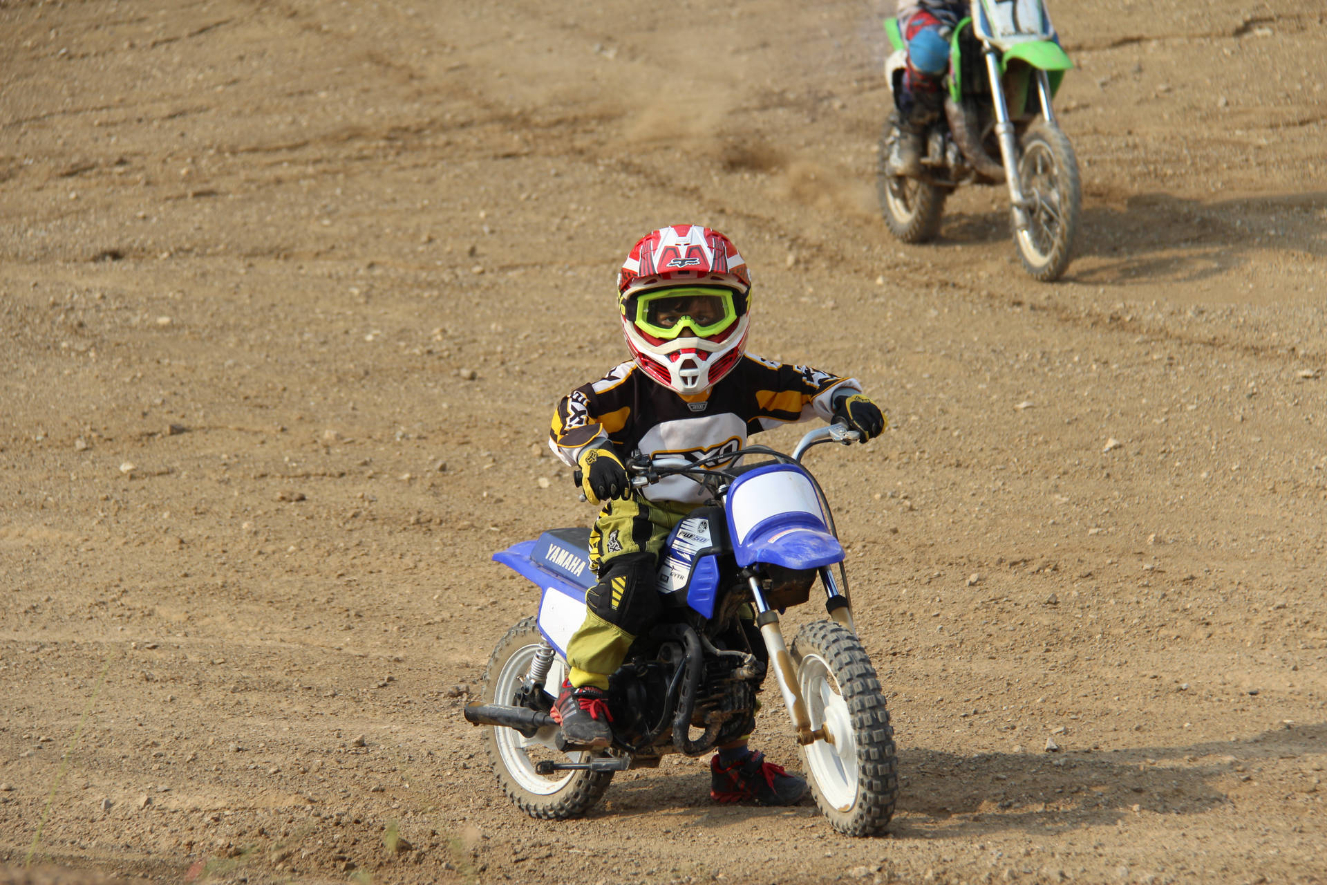 Young Racer At Motocross Racing Background