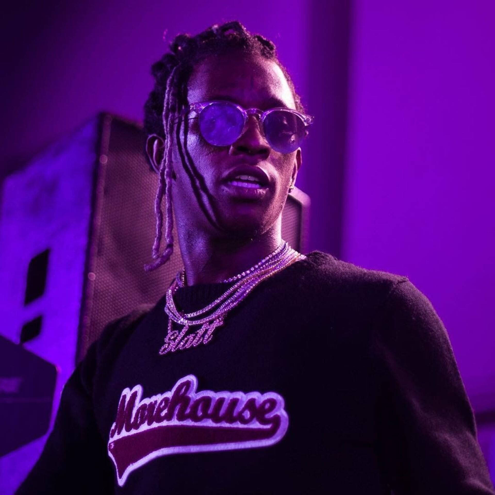 Young Thug With A Purple Lit Gun Background