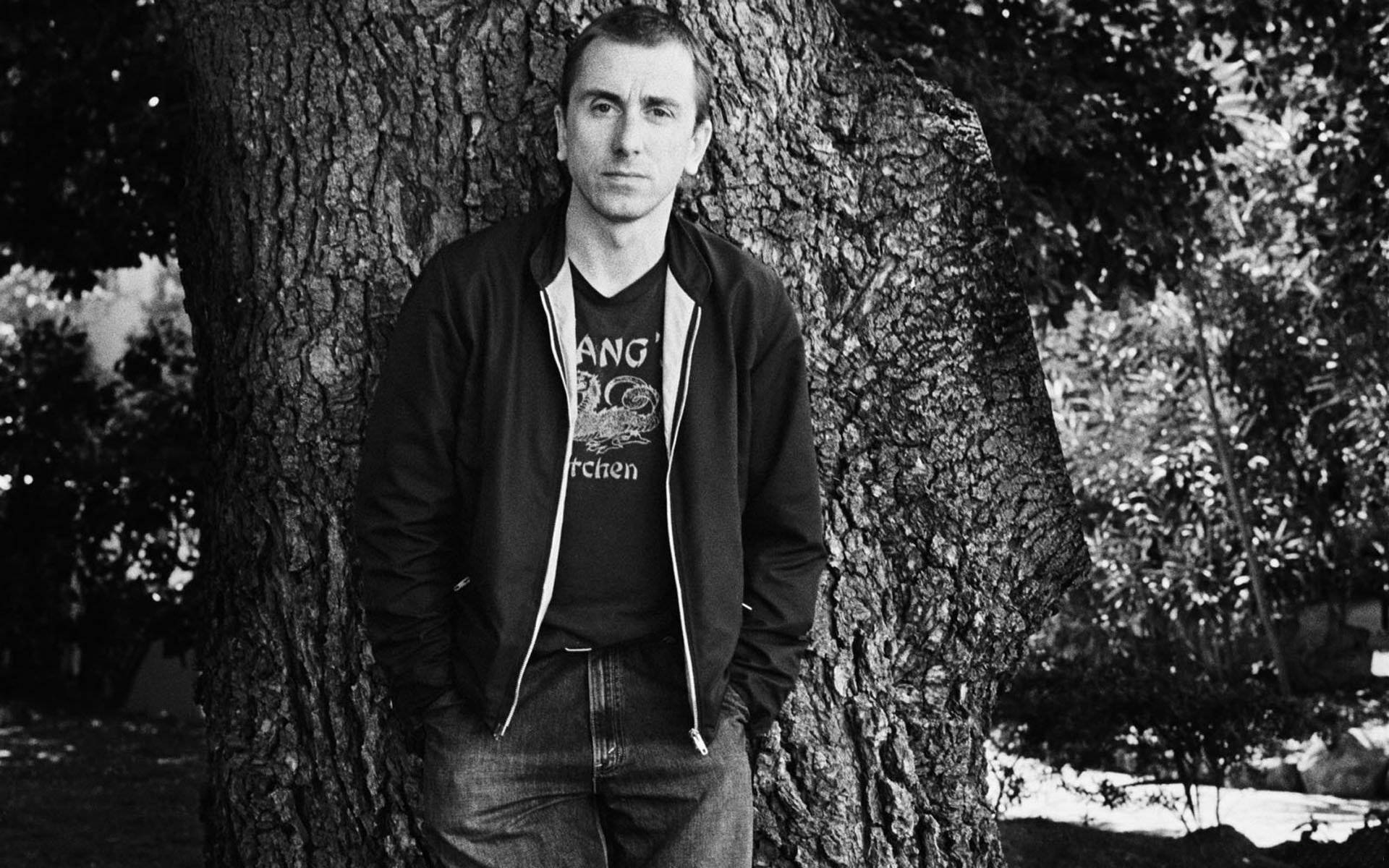 Young Tim Roth Posing By A Tree