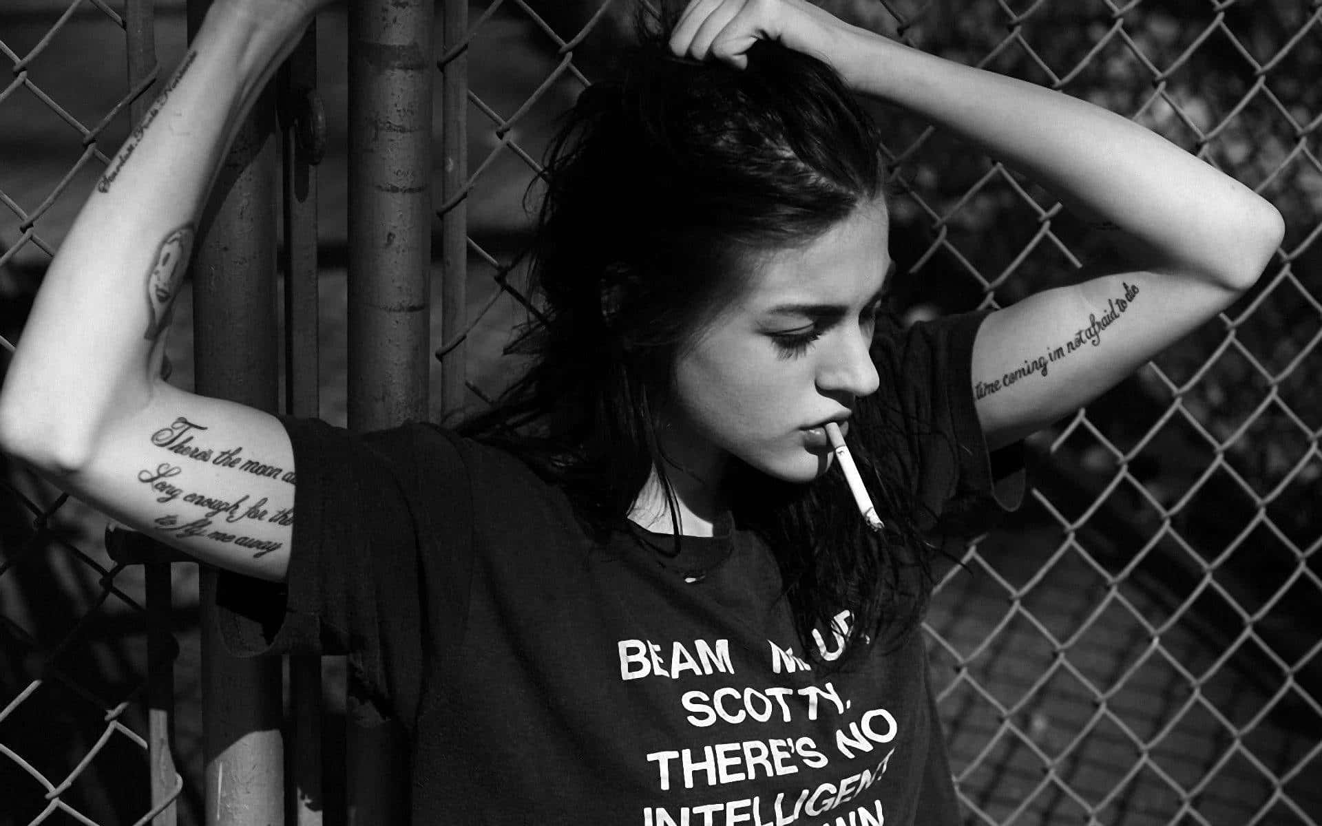 Young Woman Enjoying A Cigarette Break Background