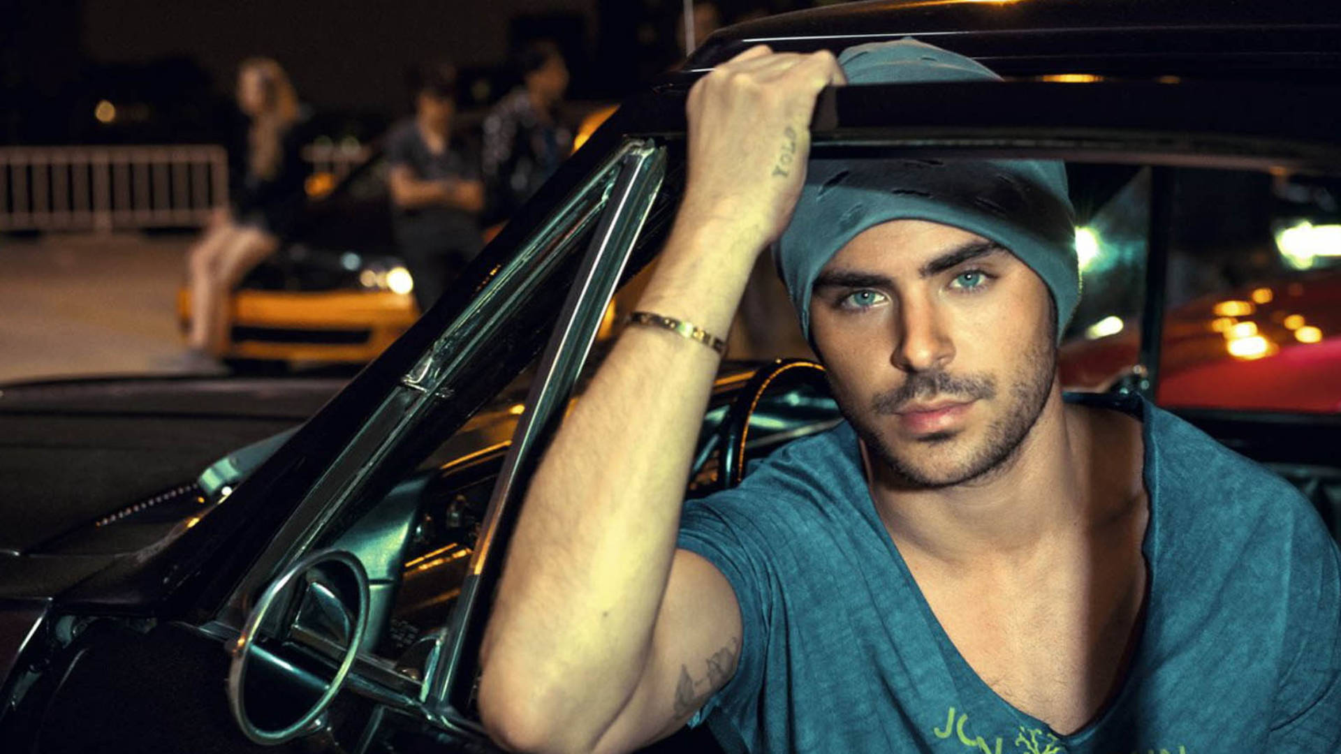 Zac Efron Enjoys A Drive In A Luxurious Car Background