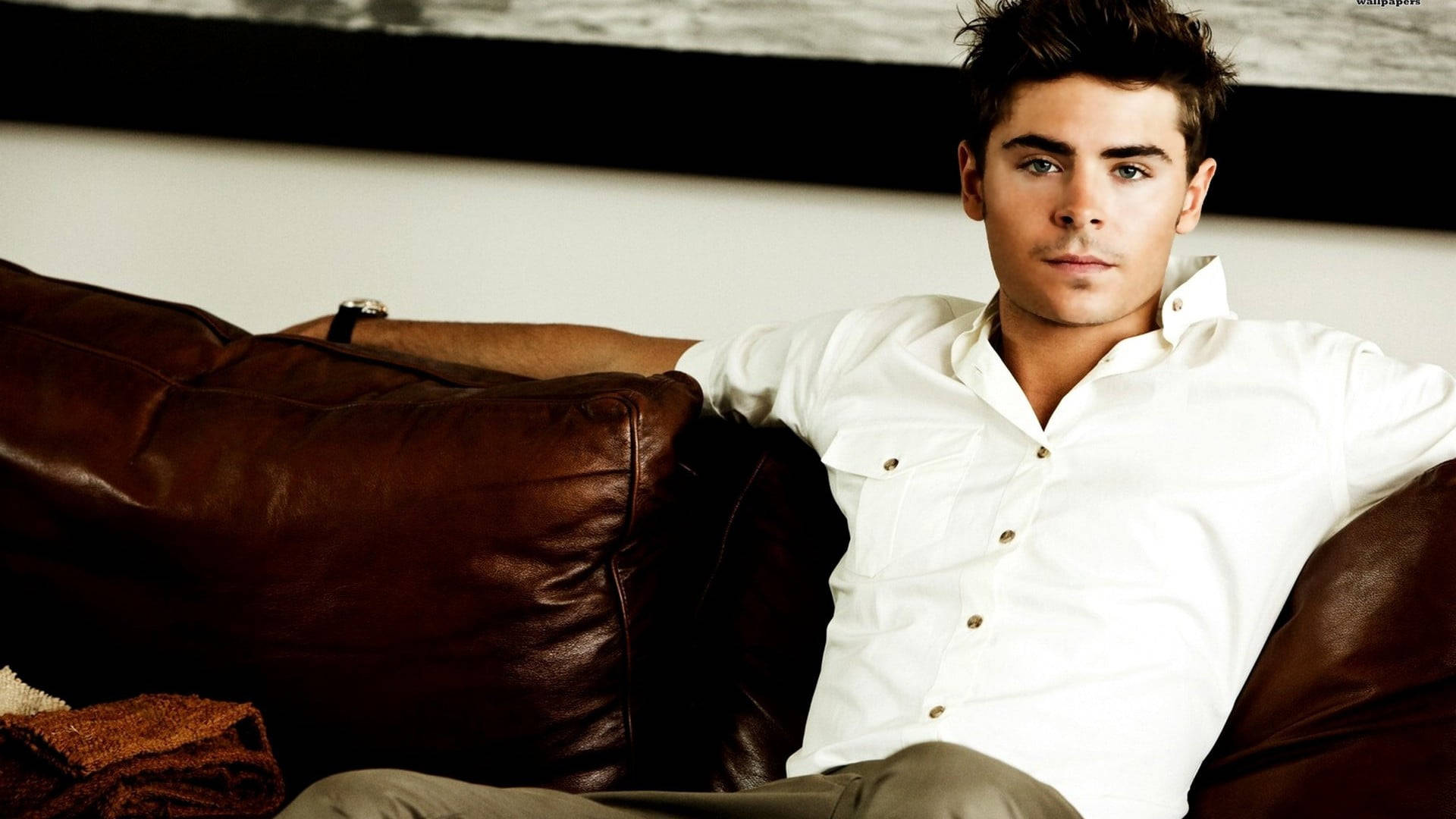 Zac Efron Reclining In Comfort Background