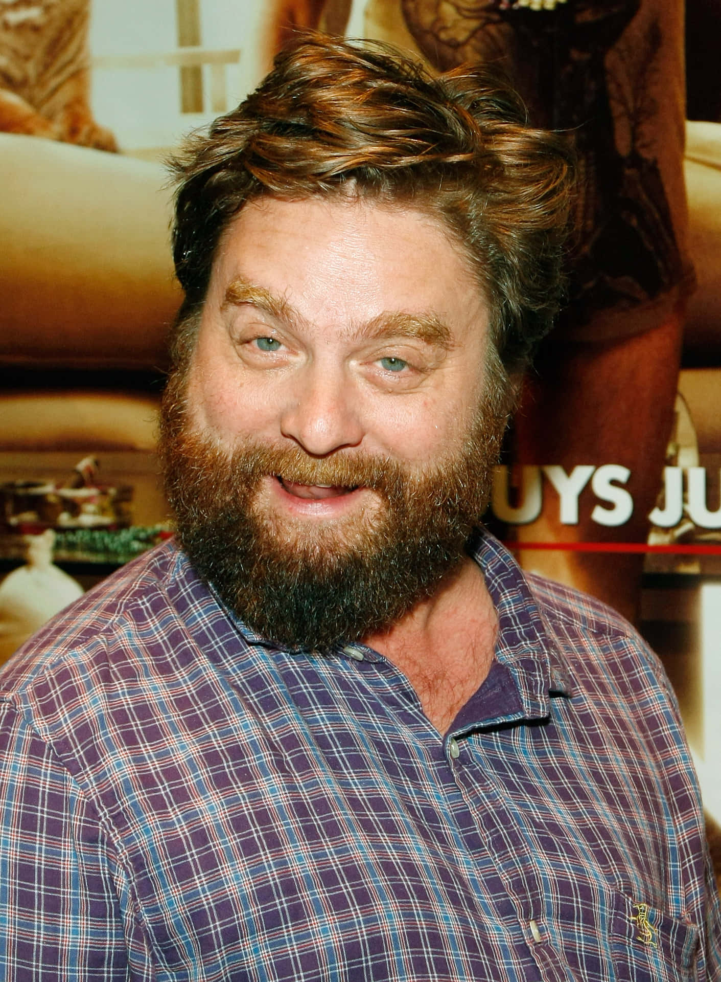 Zach Galifianakis Looking Contemplative In A Denim Jacket.