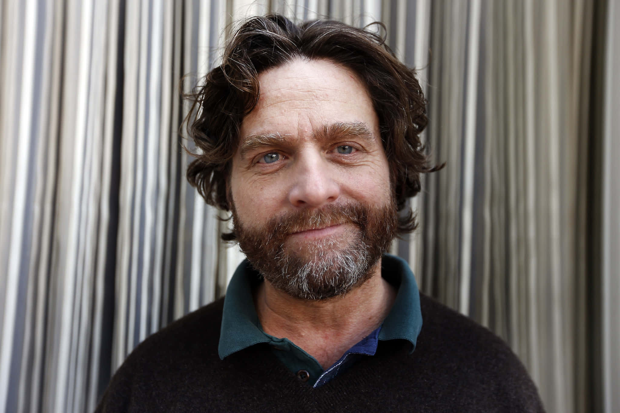 Zach Galifianakis Looking To The Side While Holding A Cup Of Coffee Background