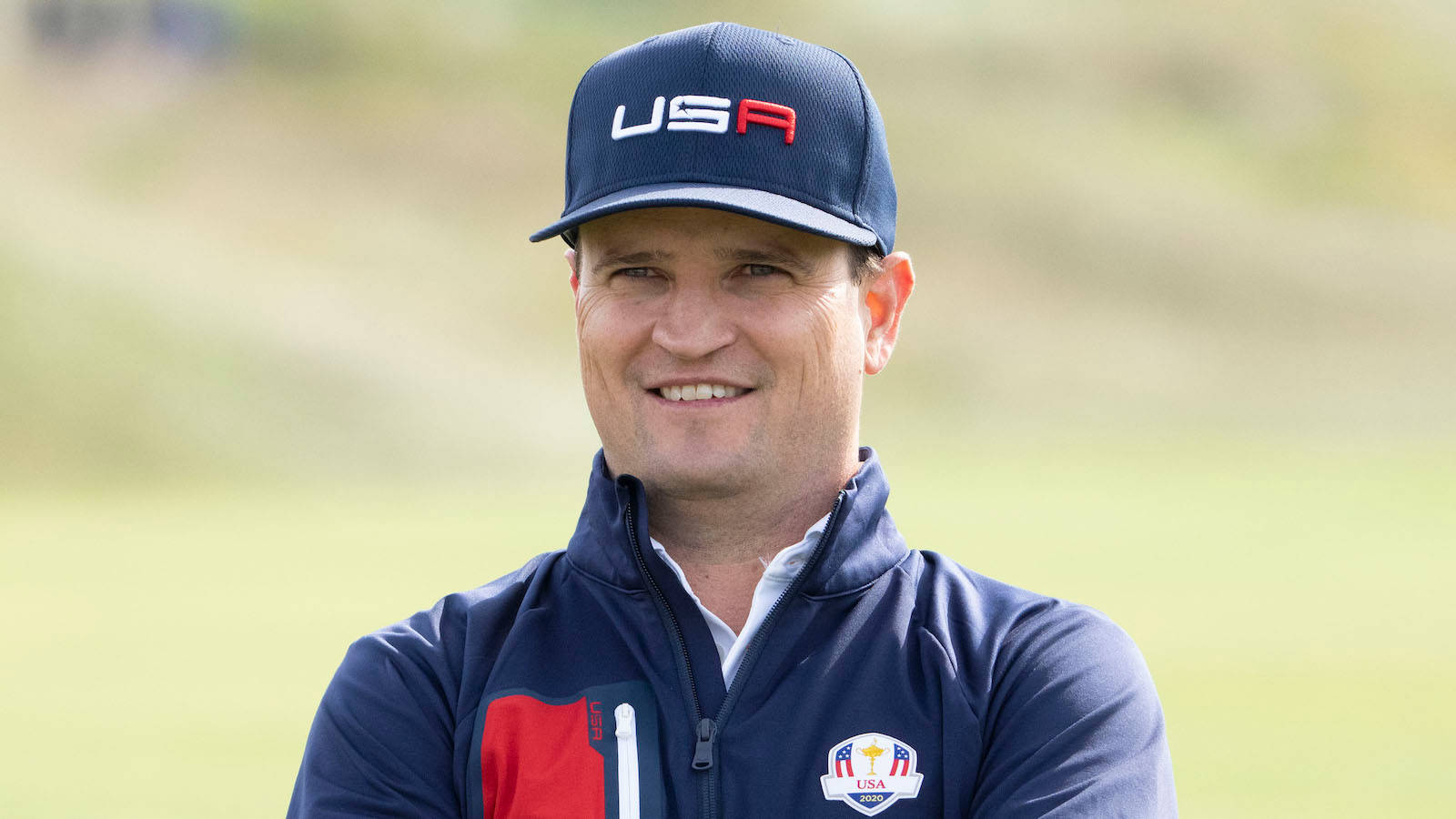 Zach Johnson Amidst A Field Background