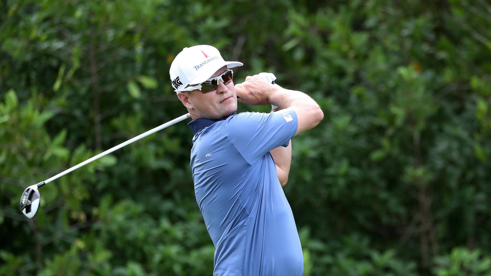 Zach Johnson Holding A Golf Club Background