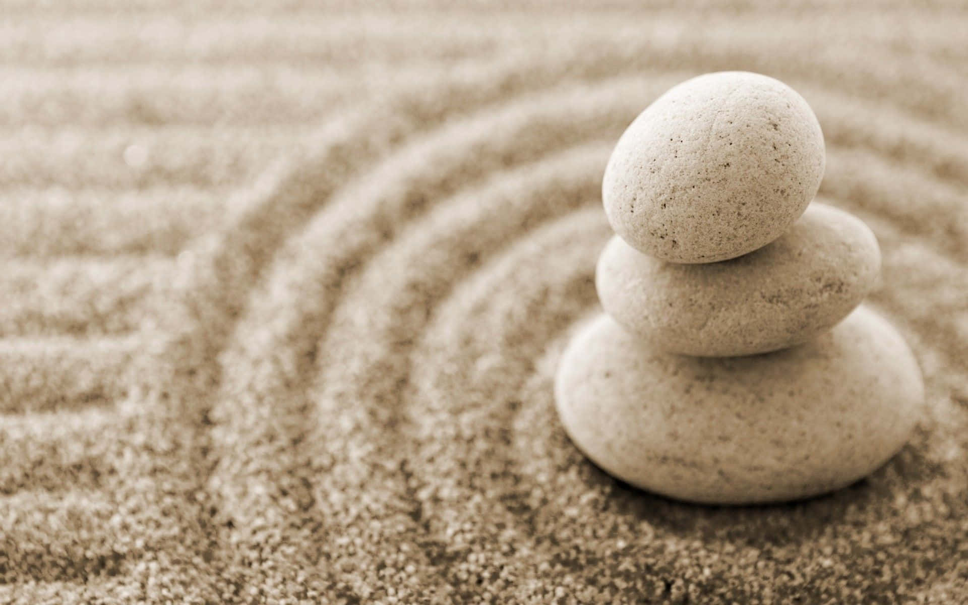 Zen Desktop Circular White Stone Stack On White Sand Background