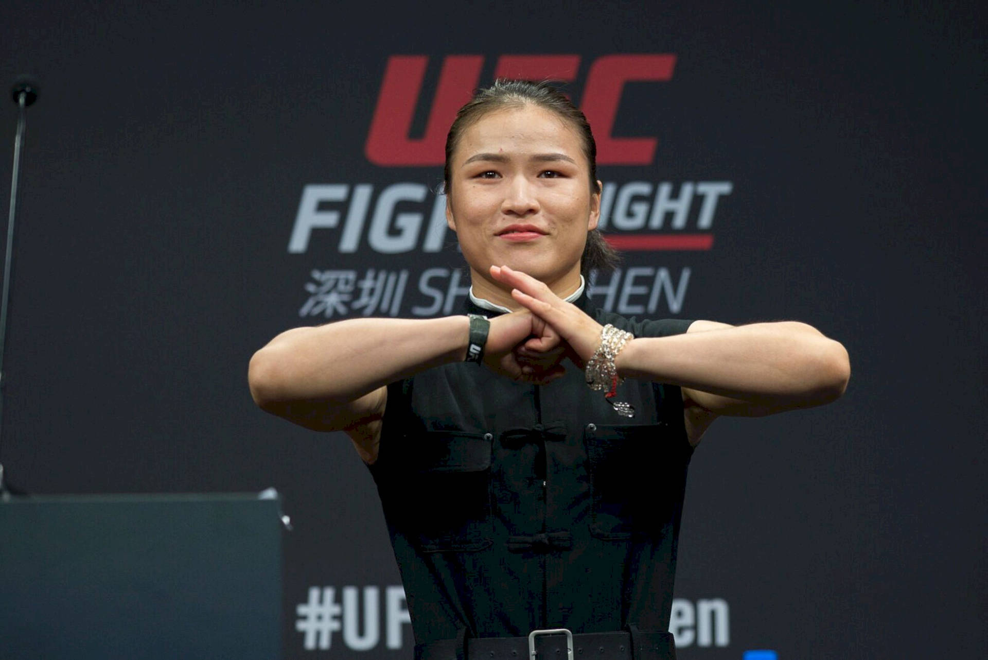 Zhang Weili Displaying Respect In Martial Arts With A Traditional Bowing Hand Gesture. Background