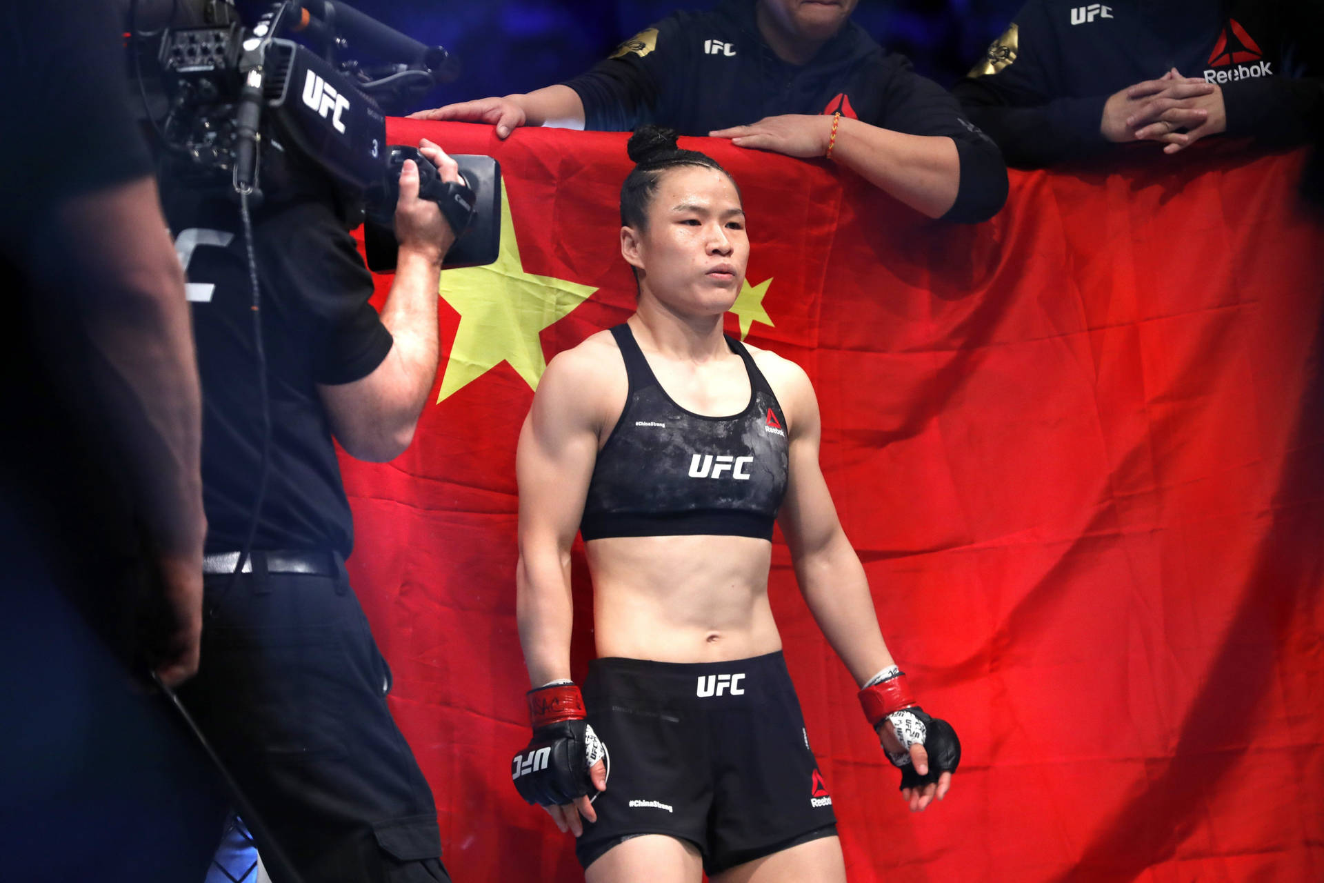 Zhang Weili Proudly Standing In Front Of Her Nation's Flag Background