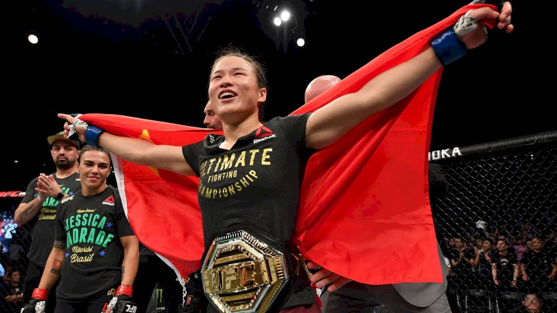 Zhang Weili Triumphantly Holding The Flag Of China Background