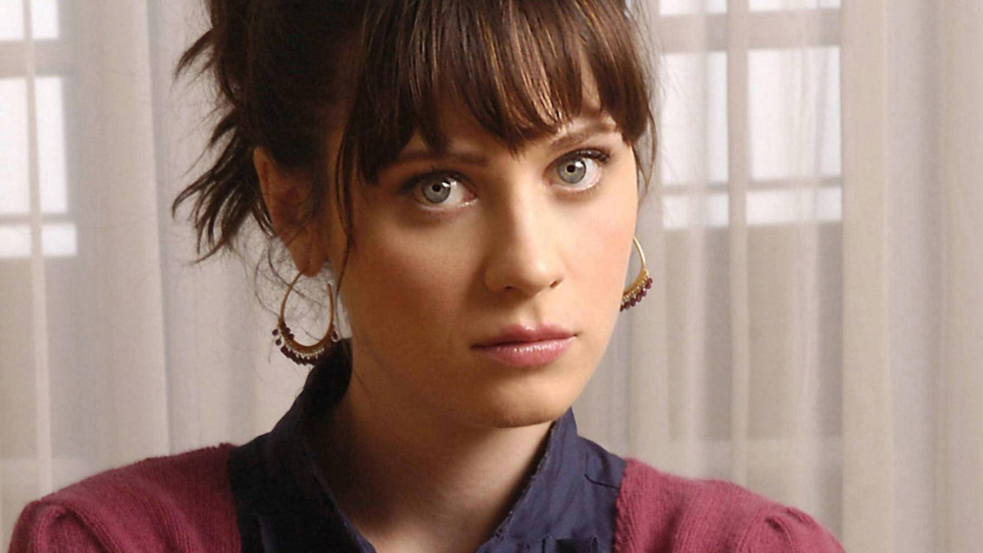 Zooey Deschanel With Hair Tied In Front Of Curtain