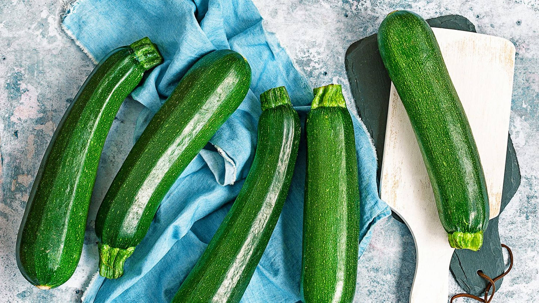 Zucchinis With Shiny Polished Green Bodies Background